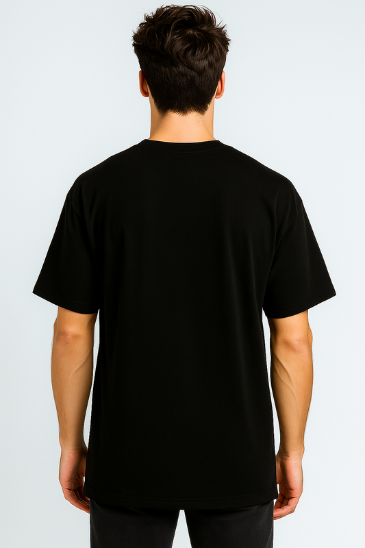 Person wearing a plain black t-shirt on a light gray background