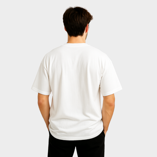 Person wearing a plain white t-shirt on a light gray background