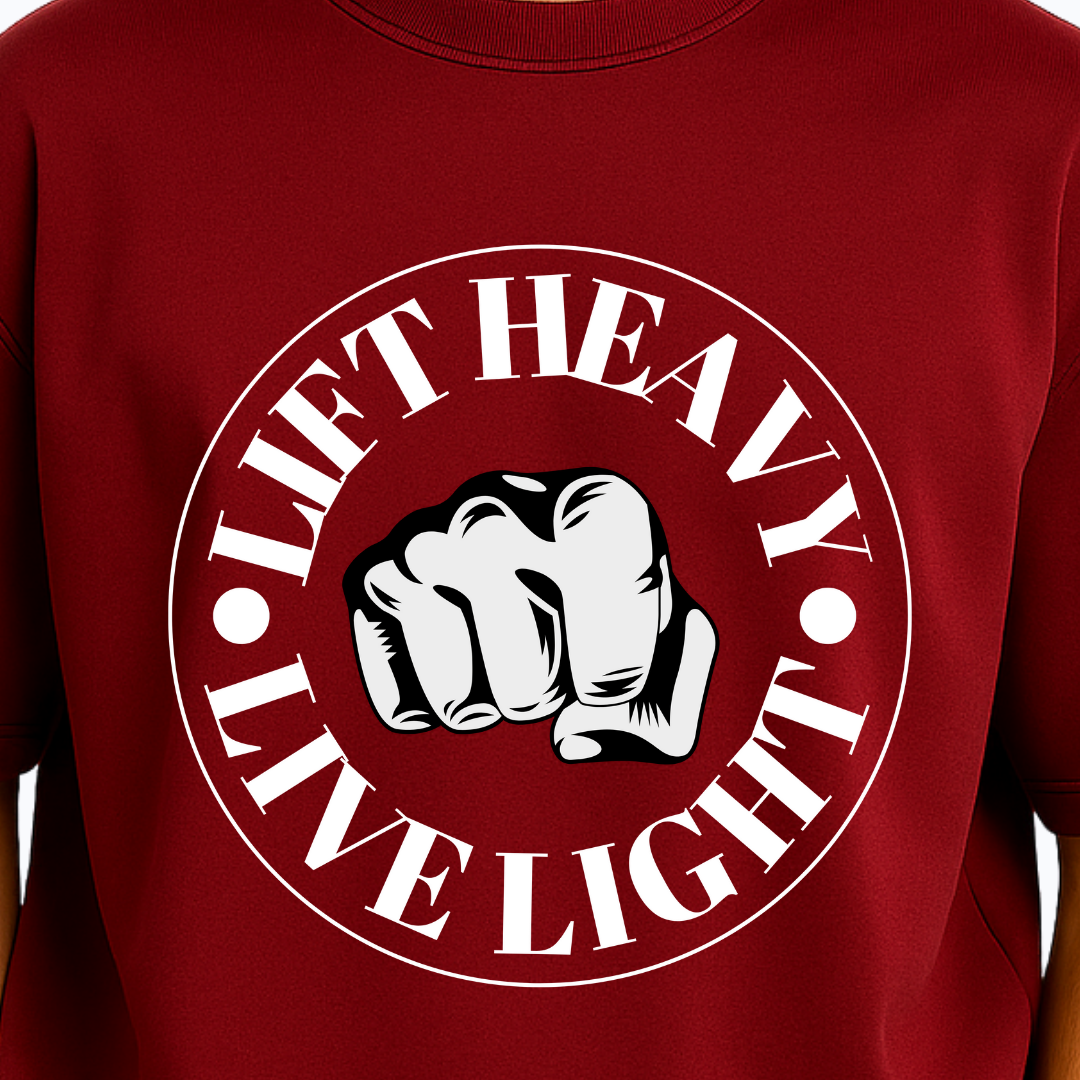 Red t-shirt with a white fist graphic and text 'Lift Heavy Live Light' on a plain background